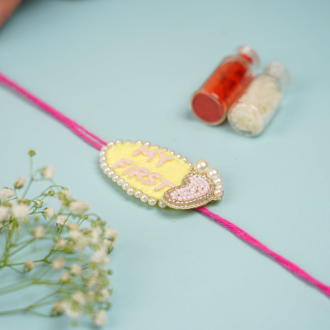 Customized Handmade Beaded My First Rakhi With Roli Chawal For Newborns 10 - Rakhi Detail with Background Props