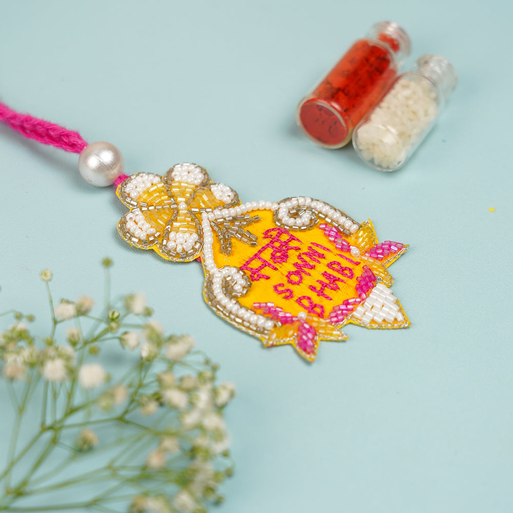 Handmade Beaded Sabse Sona Bhabhi Lumba Rakhi For Bhabhi With Roli Chawal - Top View with Decorative Elements