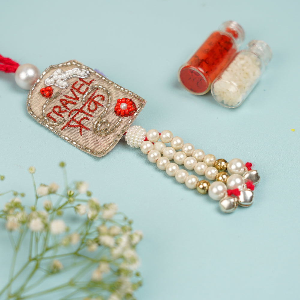 Handmade Beaded Travel Freak Lumba Rakhi For Bhabhi With Roli Chawal - Close-up View of Tassel