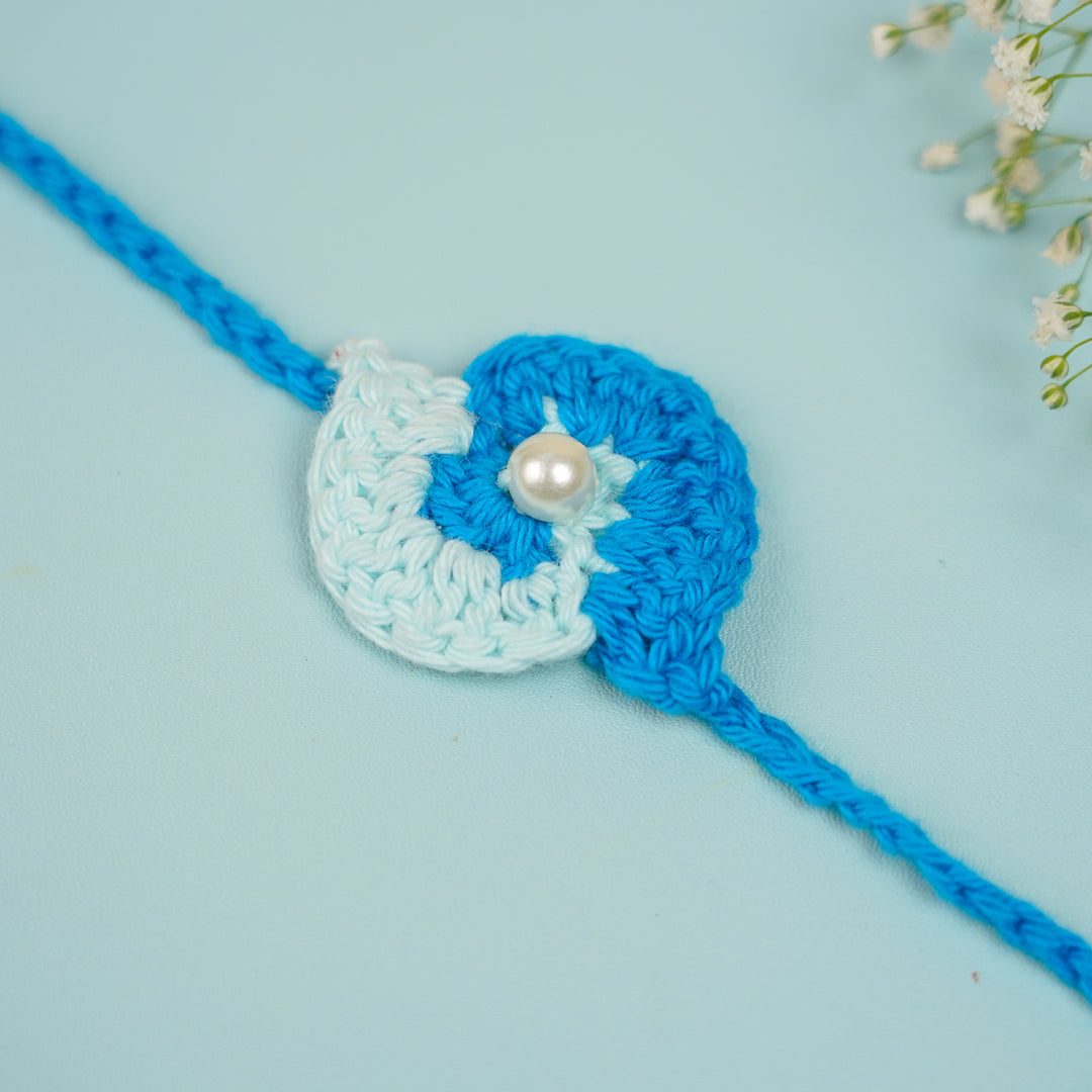 Customized Handmade Crochet Spiral Rakhi With Roli Chawal For Brother - Flat Lay Front View