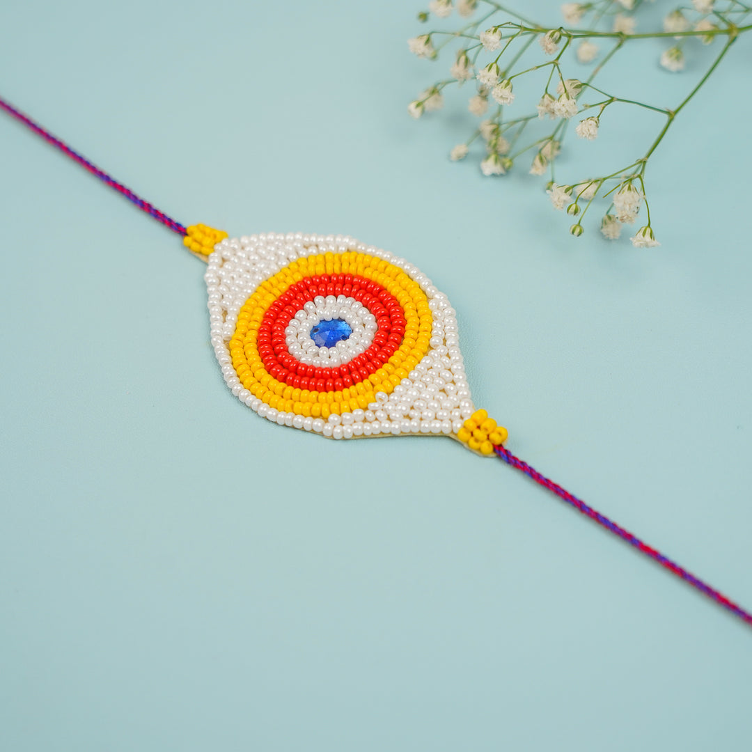 Handmade Beaded Colourful Evil Eye Rakhi With Roli Chawal - Diagonal Close-up View of Rakhi