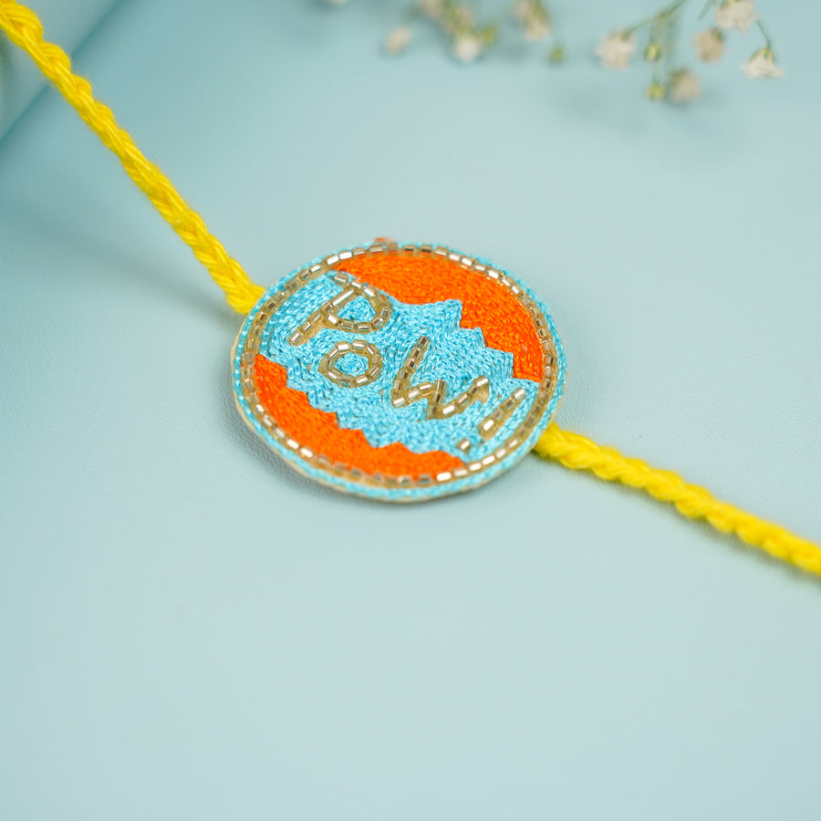 Handmade Beaded Pow Superhero Rakhi With Roli Chawal For Brother - Close-up of Rakhi detail