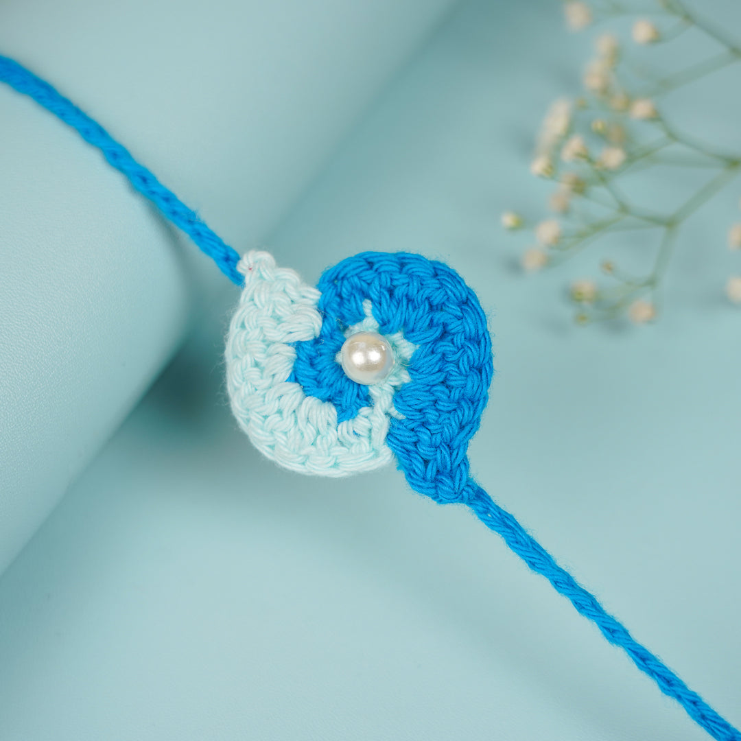 Customized Handmade Crochet Spiral Rakhi With Roli Chawal For Brother - Side View on Cylindrical Surface