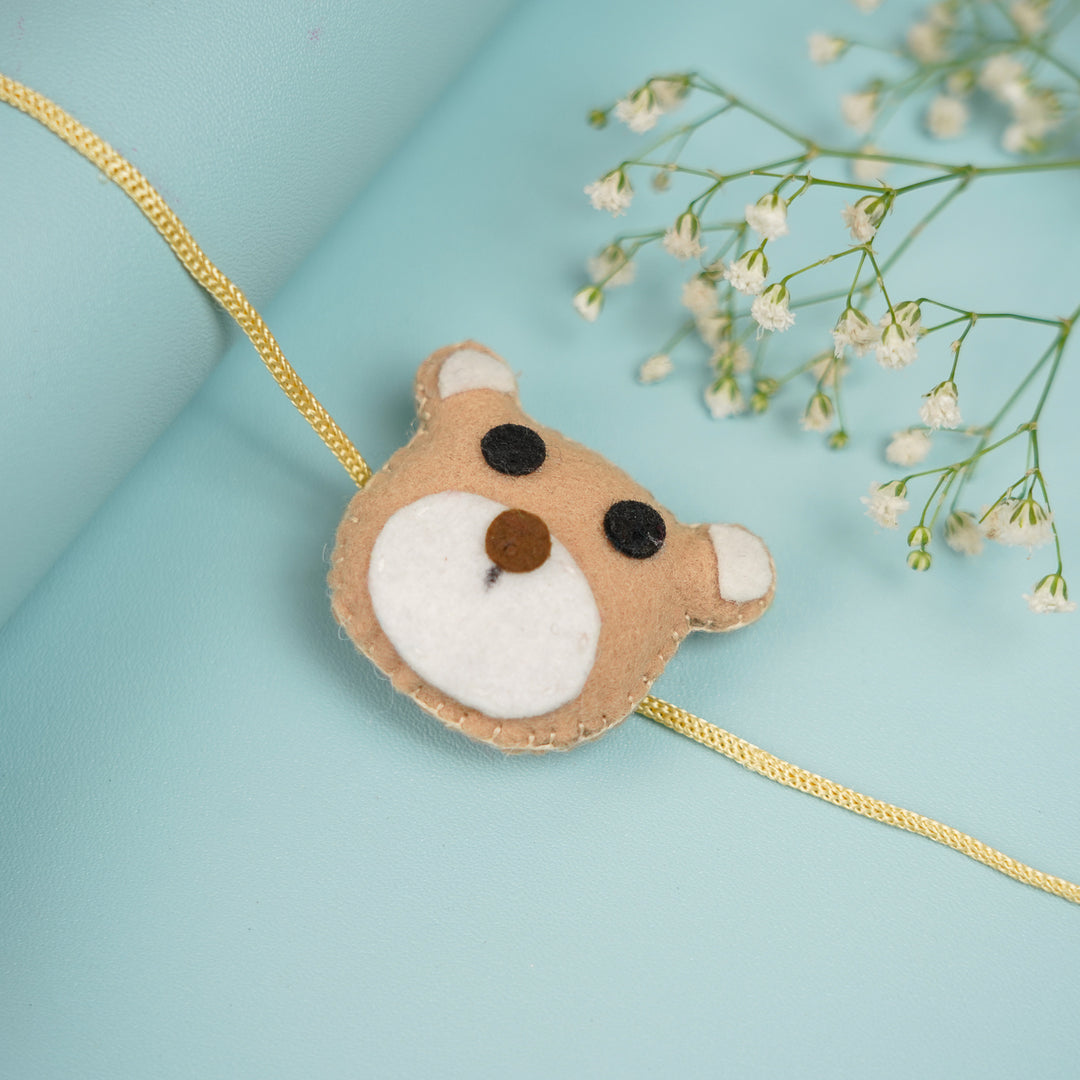 Handmade Teddy Theme Felt Rakhi With Roli Chawal - Close-up with Decorative Flowers