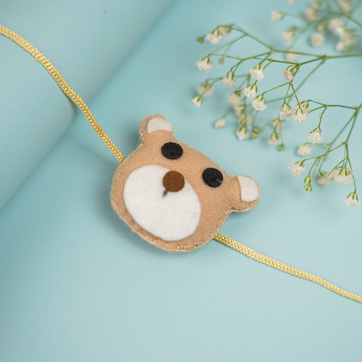 Handmade Teddy Theme Felt Rakhi With Roli Chawal - Close-up with Decorative Flowers