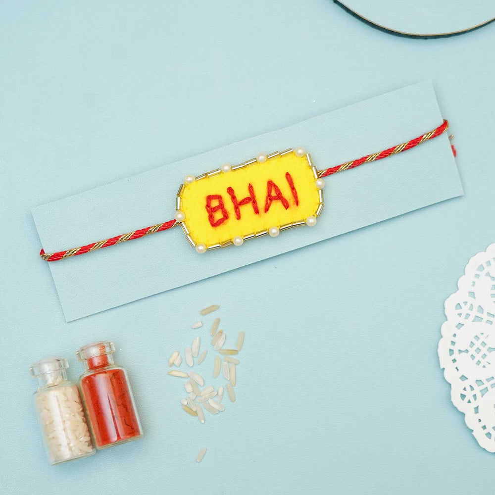 Handmade Bhai Felt Rakhi With Roli Chawal - On Greeting Card Background