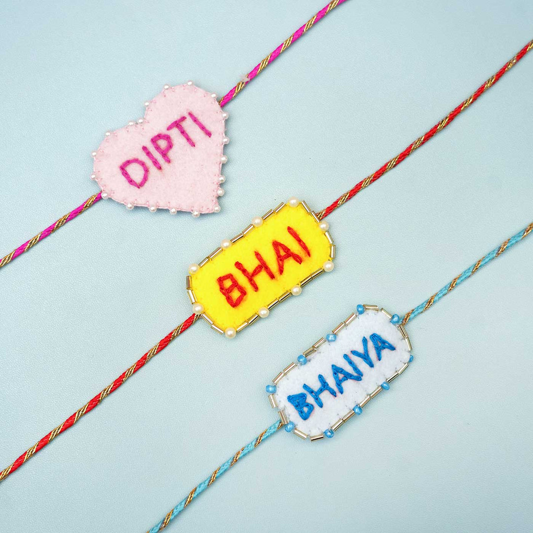 Personalized Handmade Pink Heart Felt Rakhi With Roli Chawal - Multiple personalized rakhis flat lay