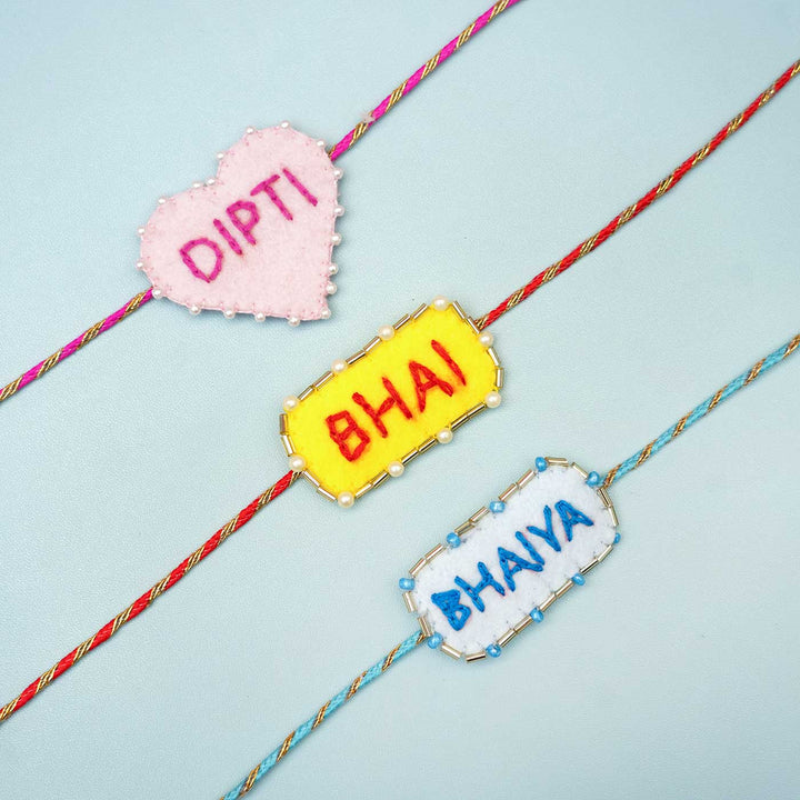 Personalized Handmade Pink Heart Felt Rakhi With Roli Chawal - Multiple personalized rakhis flat lay