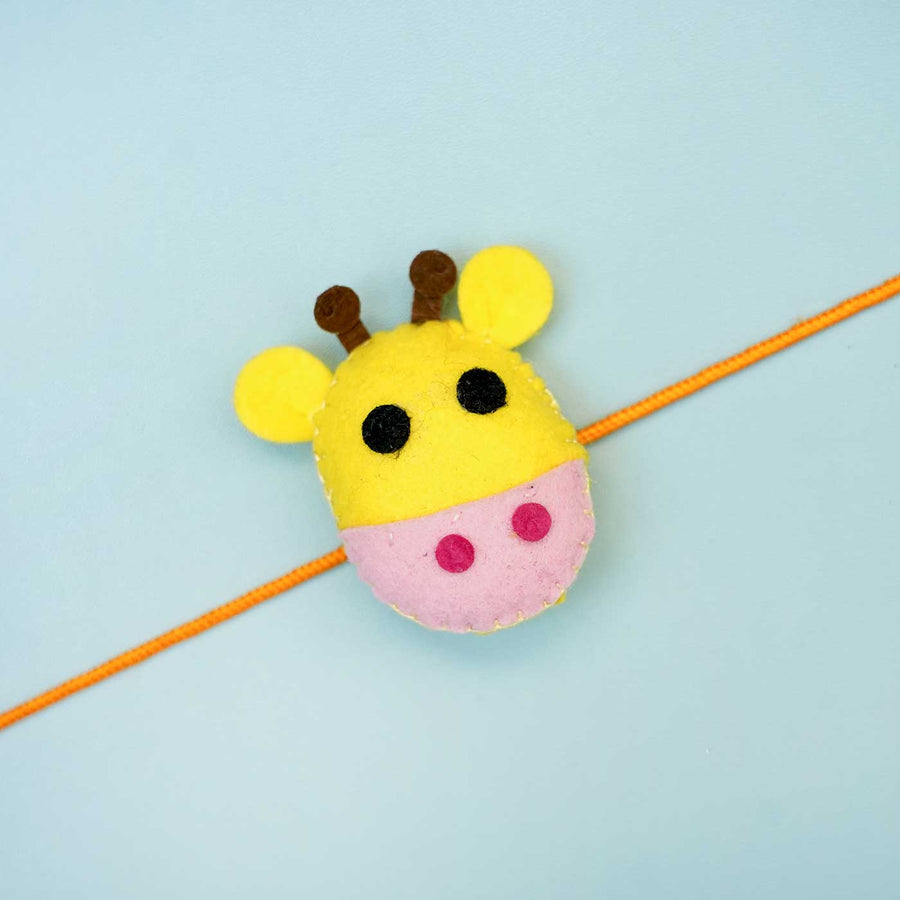 Handmade Giraffe Felt Rakhi With Roli Chawal - Close-up of Single Yellow Giraffe Rakhi