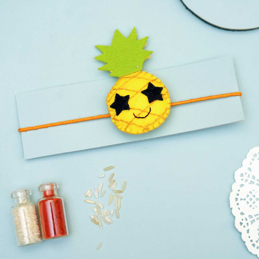 Handmade Pineapple Felt Rakhi With Roli Chawal - Pineapple Rakhi on Card Packaging