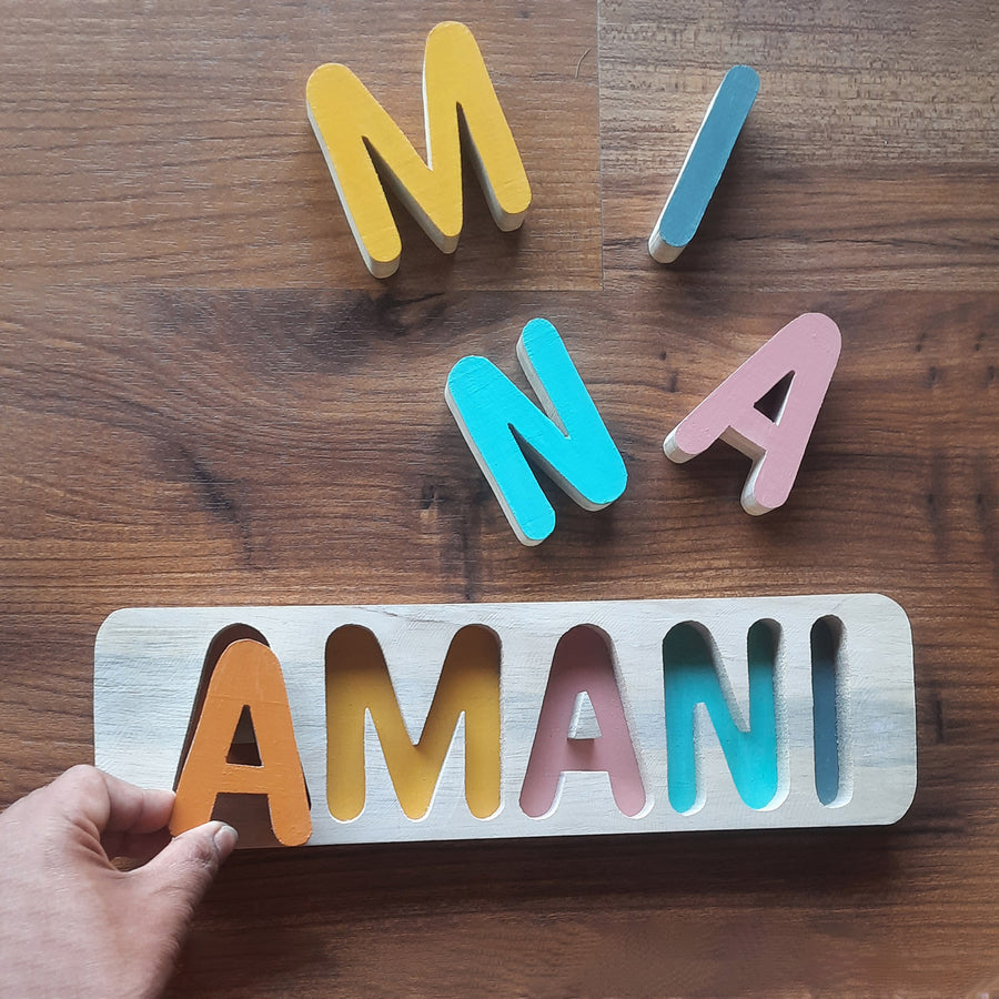 Personalized Wooden Name Puzzle - Hand placing name puzzle piece