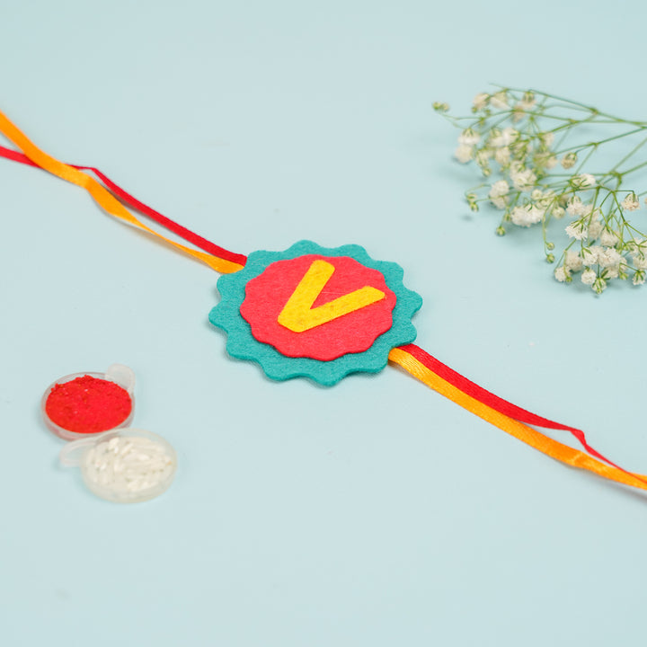 Personalized Handmade Name Initial Felt Kids Rakhi With Roli Chawal - Full product layout with accessories
