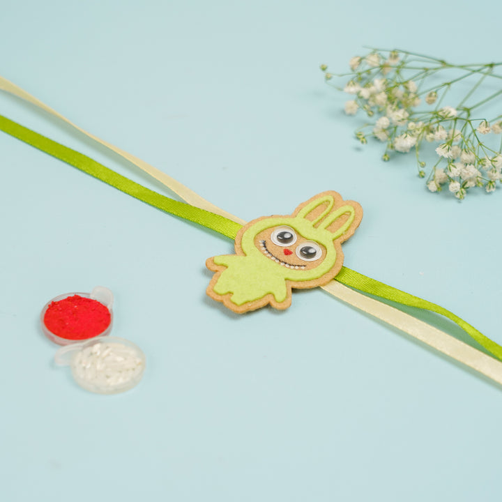 Handmade Labubu Doll Felt Kids Rakhi With Roli Chawal - Front View with Color Powder (4)