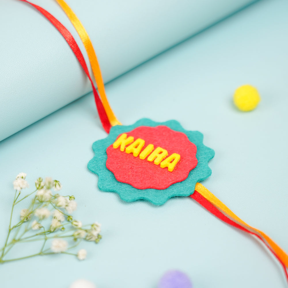 Personalized Handmade Red And Green Felt Kids Rakhi With Roli Chawal - Close-up of Personalized Rakhi