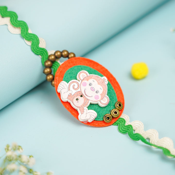Handmade Monkey Theme Felt Kids Rakhi With Roli Chawal 1 - Close-up of Monkey Embellishment