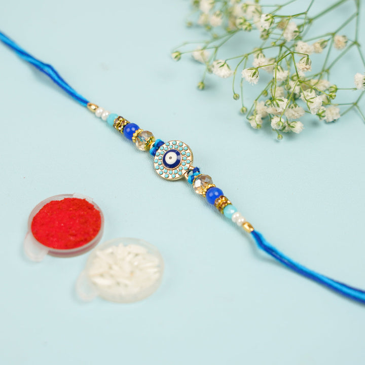 Handmade Beaded Evil Eye Rakhi With Roli Chawal 3 - Styled Flat Lay with Accessories