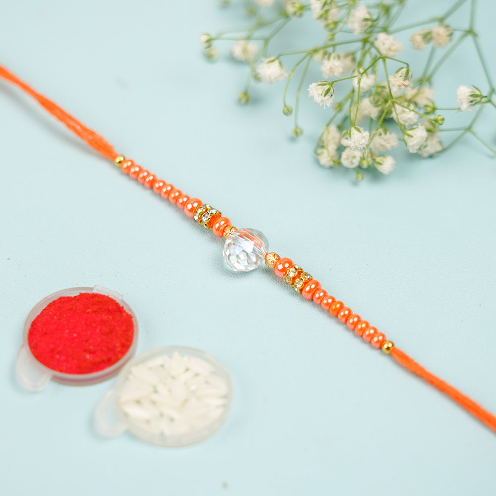 Handmade Jadtar Crystal Bhaiya Bhabhi Rakhi With Roli Chawal Set Of 2 - Flat lay with decorative powders