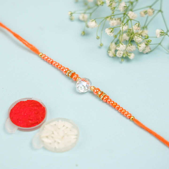 Handmade Jadtar Crystal Bhaiya Bhabhi Rakhi With Roli Chawal Set Of 2 - Flat lay with decorative powders