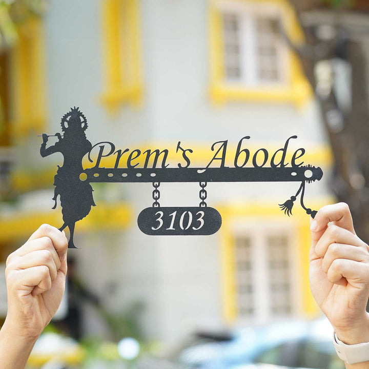 Personalized Krishna Weatherproof Name Plate With House Number - Held in Hands With Background Blur