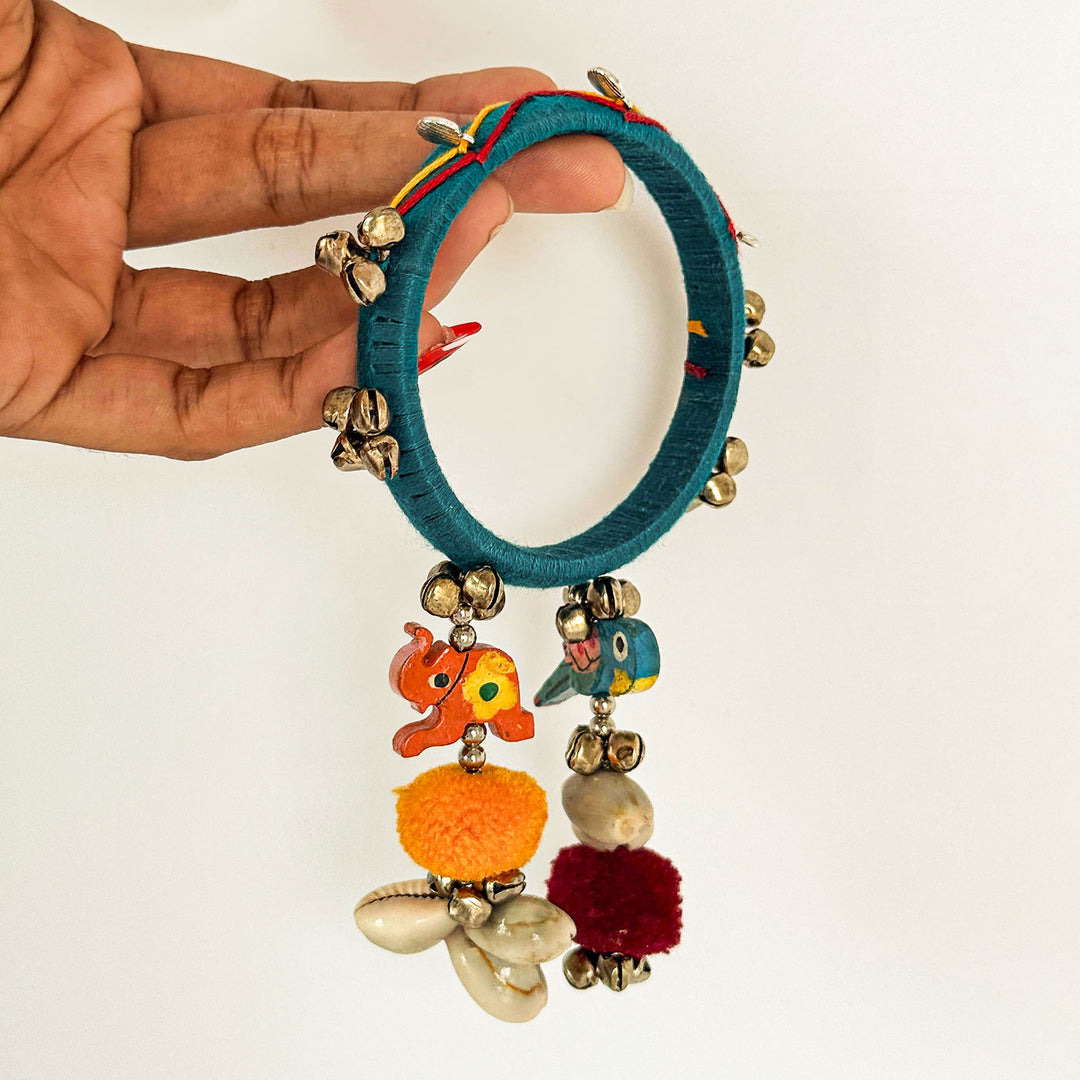 Handmade Beaded Ghungroo And Pom Pom Charm Cotton Bangle Lumba With Roli Chawal For Bhabhi - Held by Hand