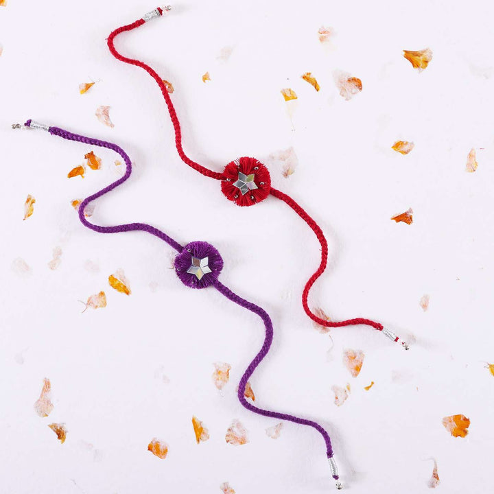 Handmade Mirror Work Floral Rakhi With Roli Chawal Set Of 2 - Flat Lay with Petal Decoration