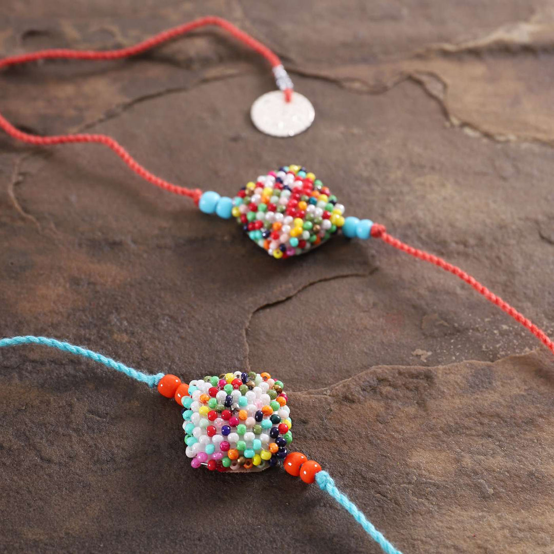 Handmade Beaded Square Rakhi With Roli Chawal Set Of 2 - Close-up of Beaded Centerpiece