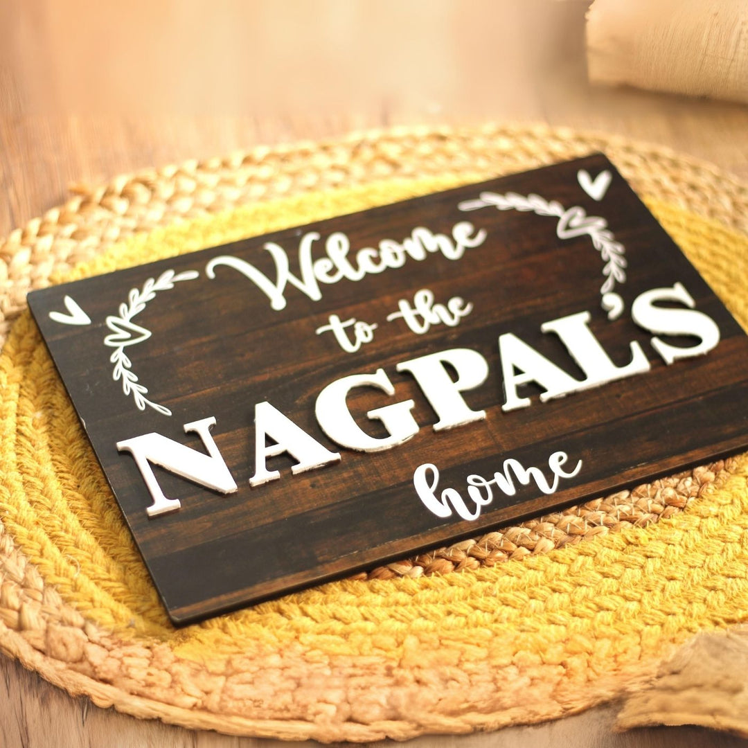 Personalized Printed Welcome To Our Home Mdf Wood Name Plate With 3D Letters - Top Angle on Surface Display