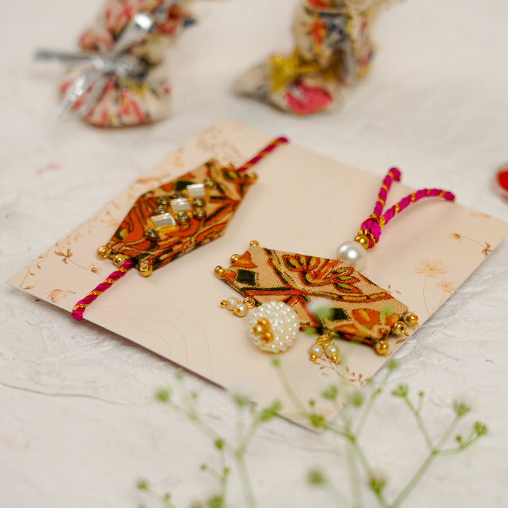 Handmade Sequin Embroidery Hexagon Kundan Bhaiya Bhabhi Rakhi With Roli Chawal Set Of 2 - Pair Angled View on Card