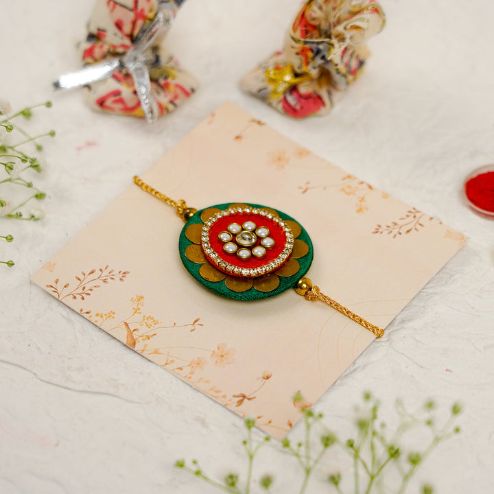 Handmade Mandala Kundan Flower Rakhi With Roli Chawal - Angled Side View with Accessories