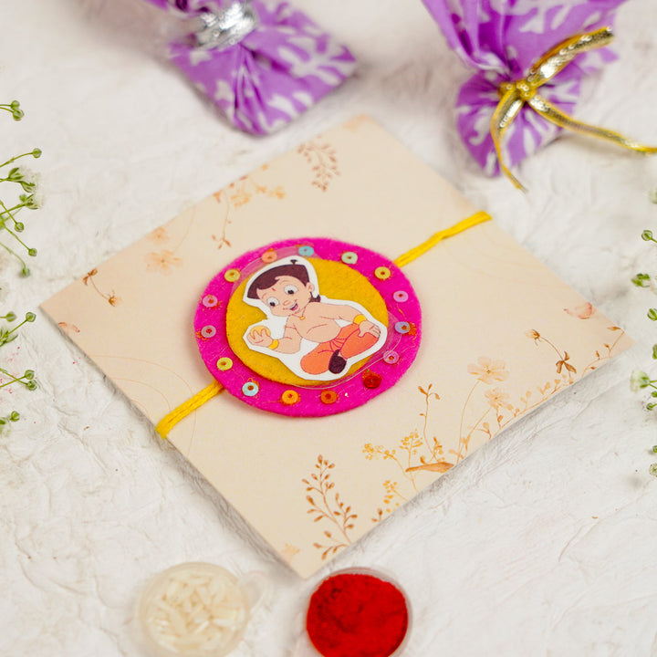 Handmade Chota Bheem With Ladoo Rakhi With Roli Chawal - Flat Lay with Packaging and Items