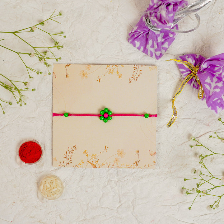 Handmade Beaded Flower Rakhi With Roli Chawal - Flat lay with box and accessories (24)