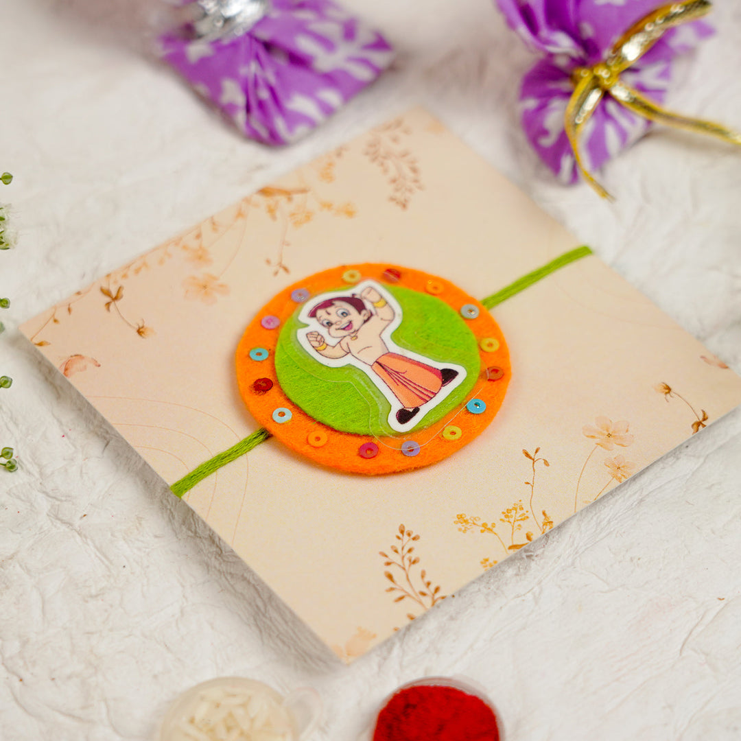 Handmade Chota Bheem Kids Rakhi With Roli Chawal - Angled View with Packaging Elements