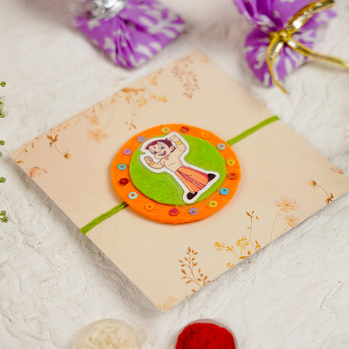 Handmade Chota Bheem Kids Rakhi With Roli Chawal - Angled View with Packaging Elements