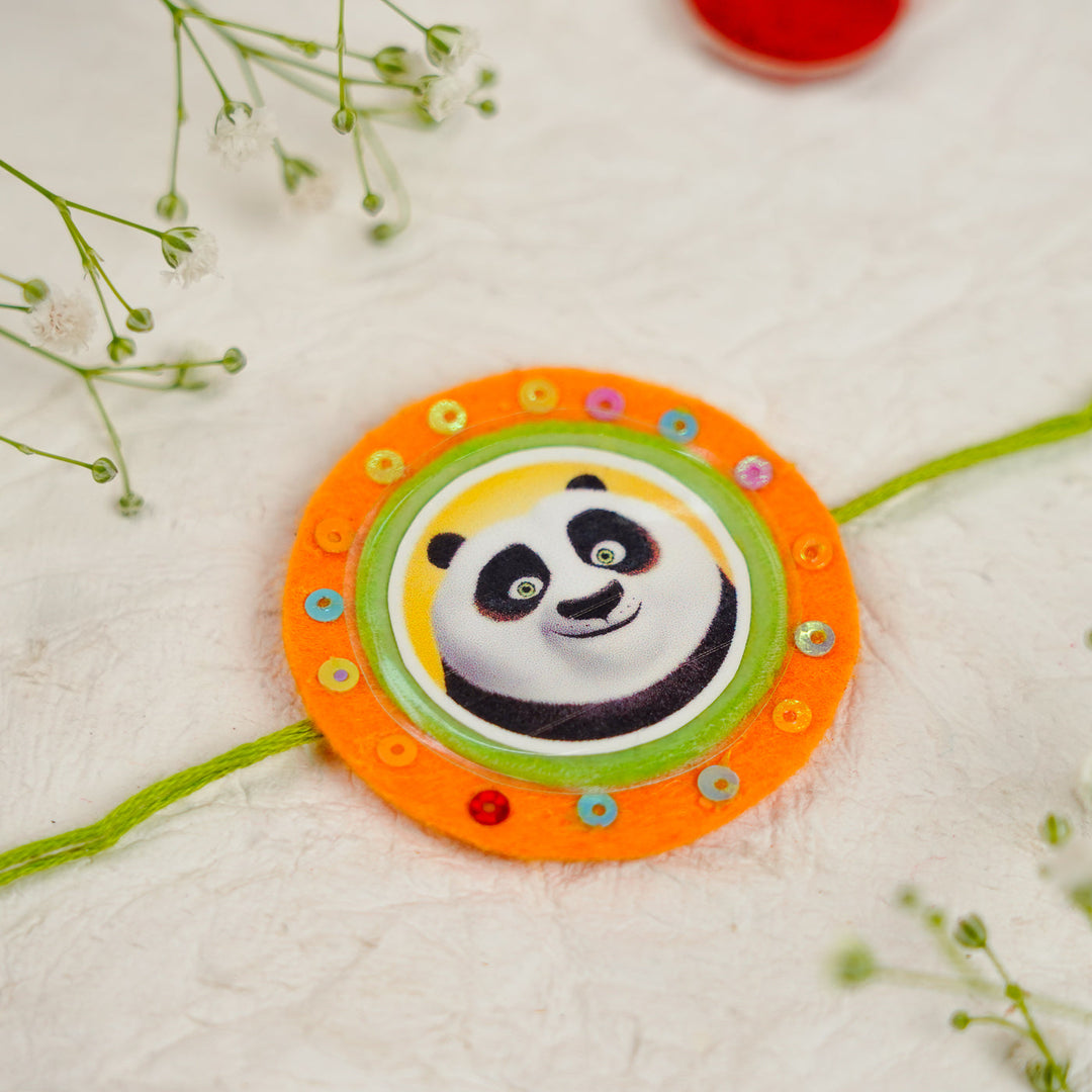 Handmade Kung Fu Panda Kids Rakhi With Roli Chawal - Close-up on Flat Surface (8)