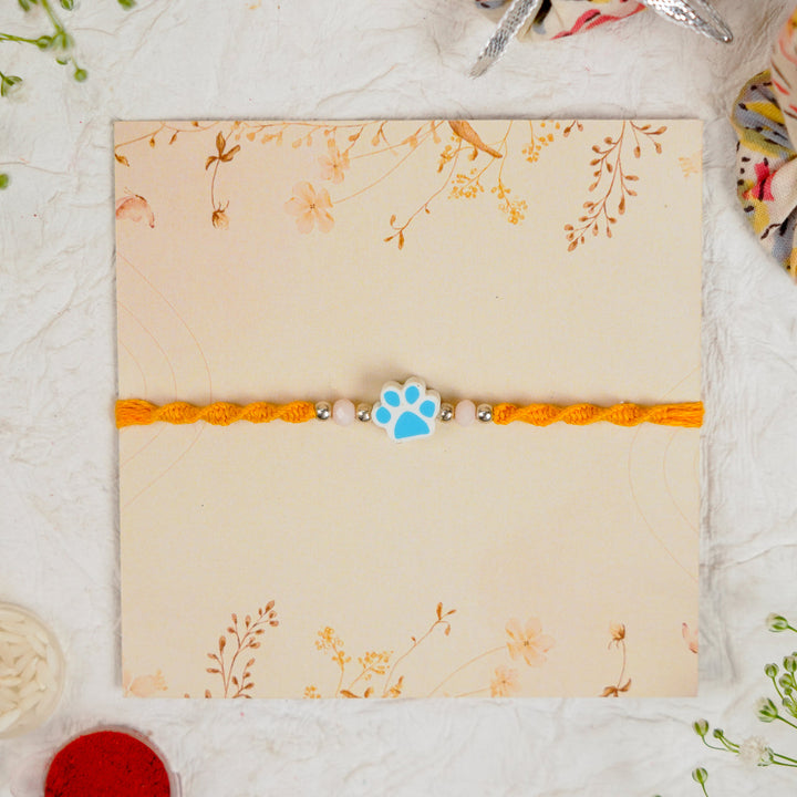 Handmade Paw Kids Rakhi With Roli Chawal - Front View Blue Paw Charm