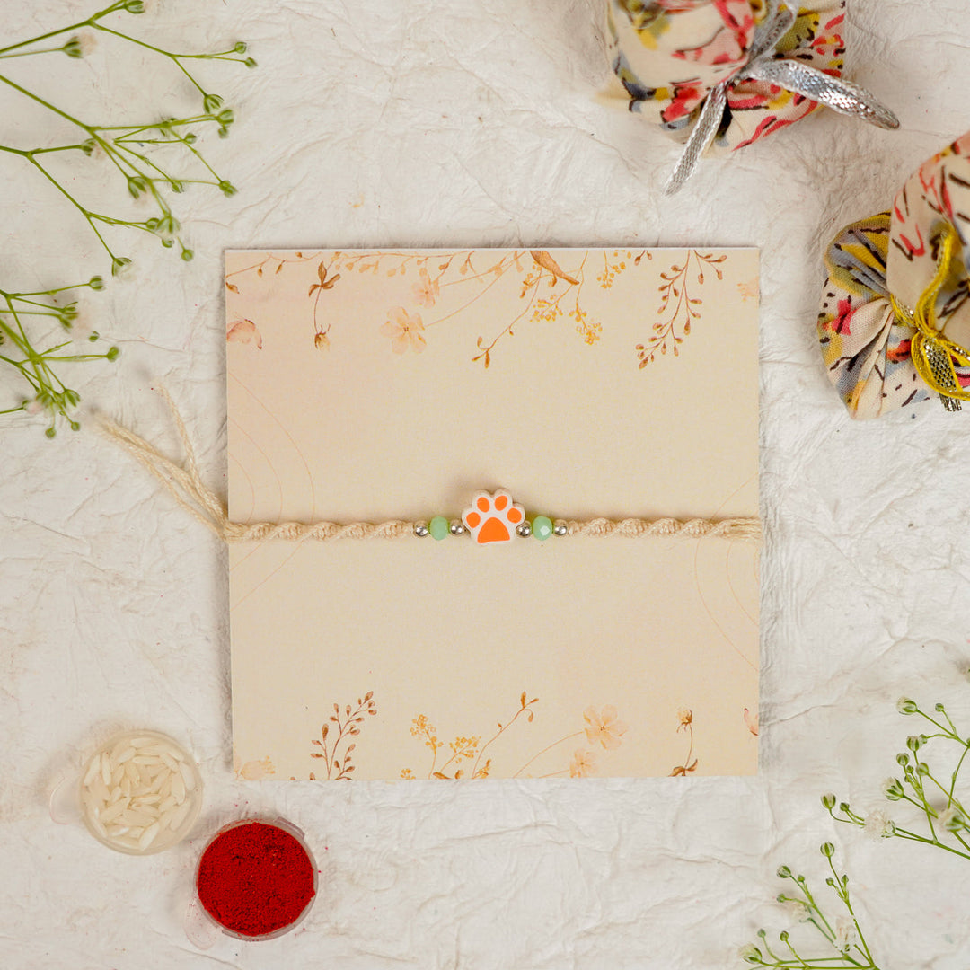 Handmade Paw Kids Rakhi With Roli Chawal - Front View Orange Paw Charm