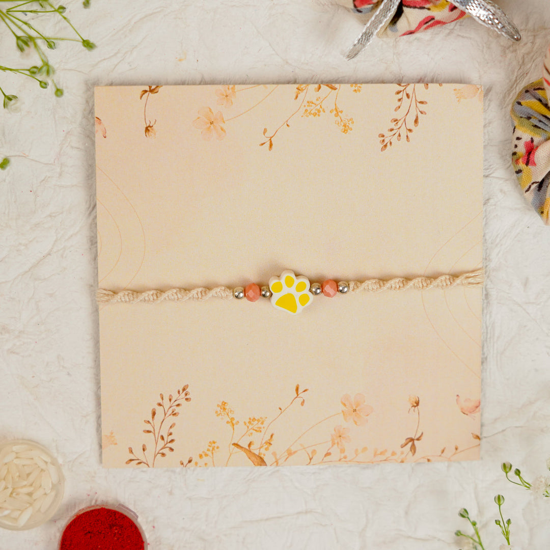 Handmade Paw Kids Rakhi With Roli Chawal - Front View Yellow Paw Charm
