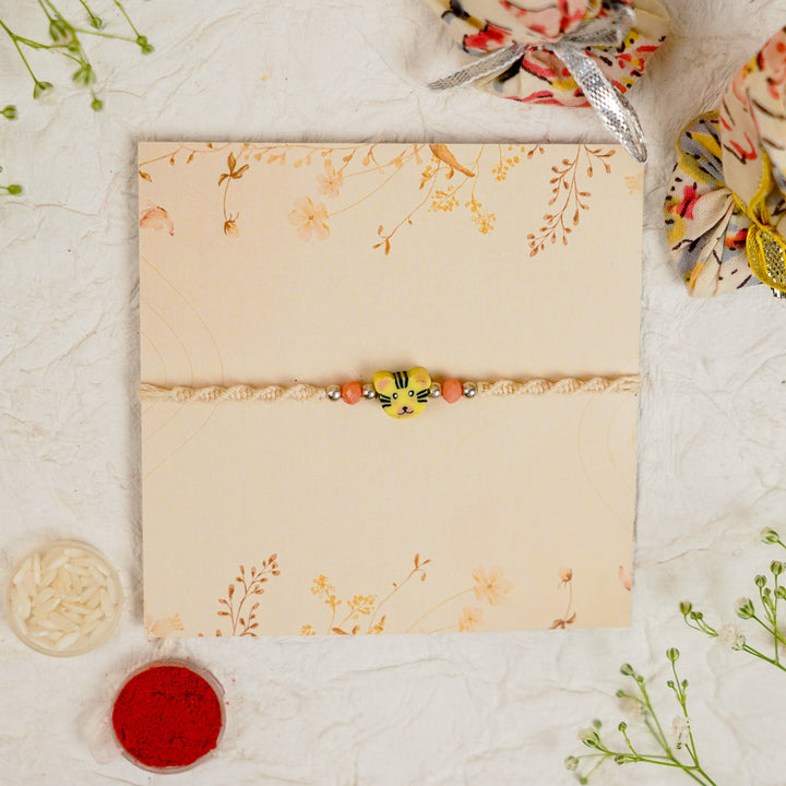 Handmade Tiger Kids Rakhi With Roli Chawal - Flat lay with packaging and accessories