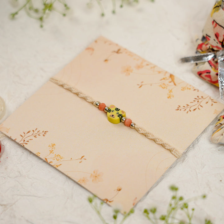 Handmade Tiger Kids Rakhi With Roli Chawal - Angled view with decorative elements
