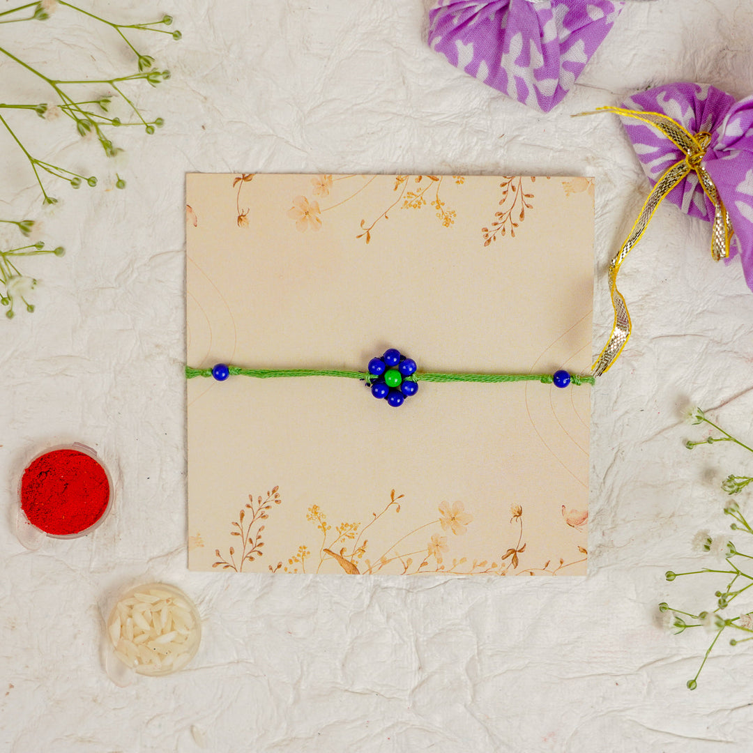 Handmade Beaded Flower Rakhi With Roli Chawal - Flat lay with box and accessories (4)