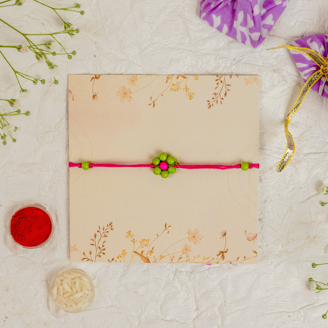 Handmade Beaded Flower Rakhi With Roli Chawal - Flat lay with box and accessories (6)