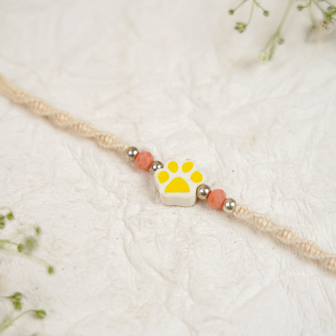 Handmade Paw Kids Rakhi With Roli Chawal - Close-up Yellow Paw Charm