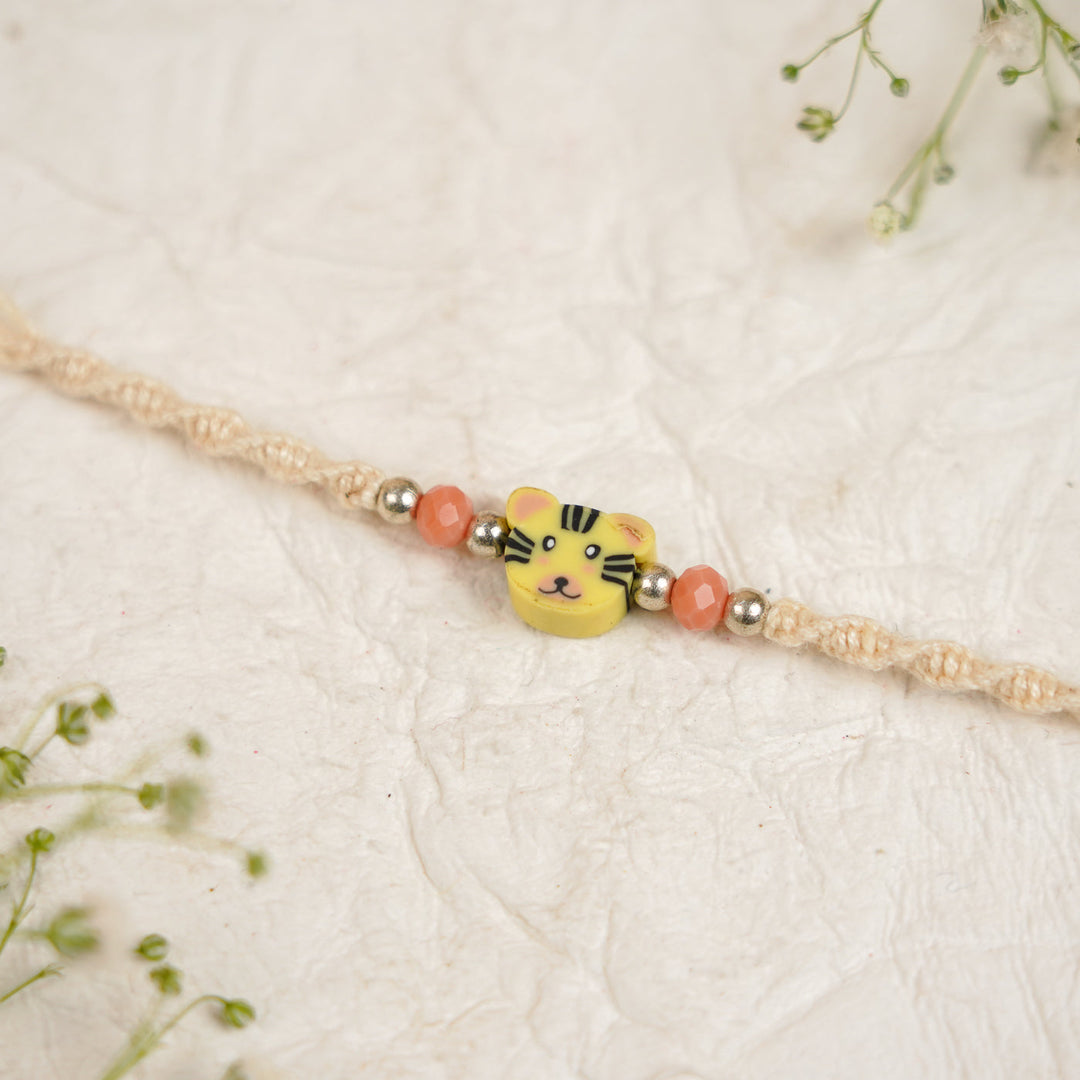 Handmade Tiger Kids Rakhi With Roli Chawal - Close-up of bracelet centerpiece