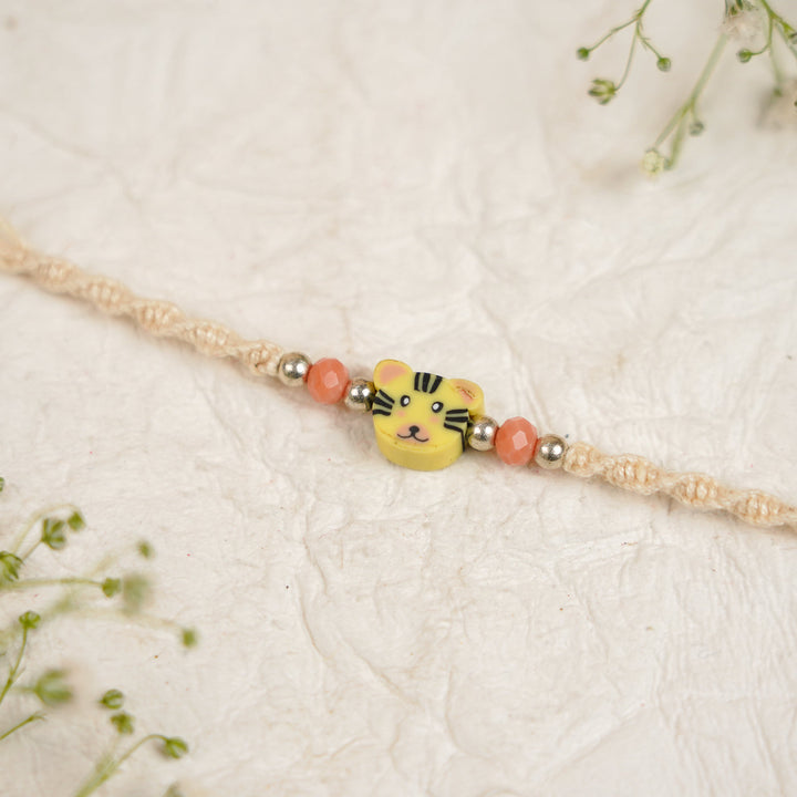 Handmade Tiger Kids Rakhi With Roli Chawal - Close-up of bracelet centerpiece