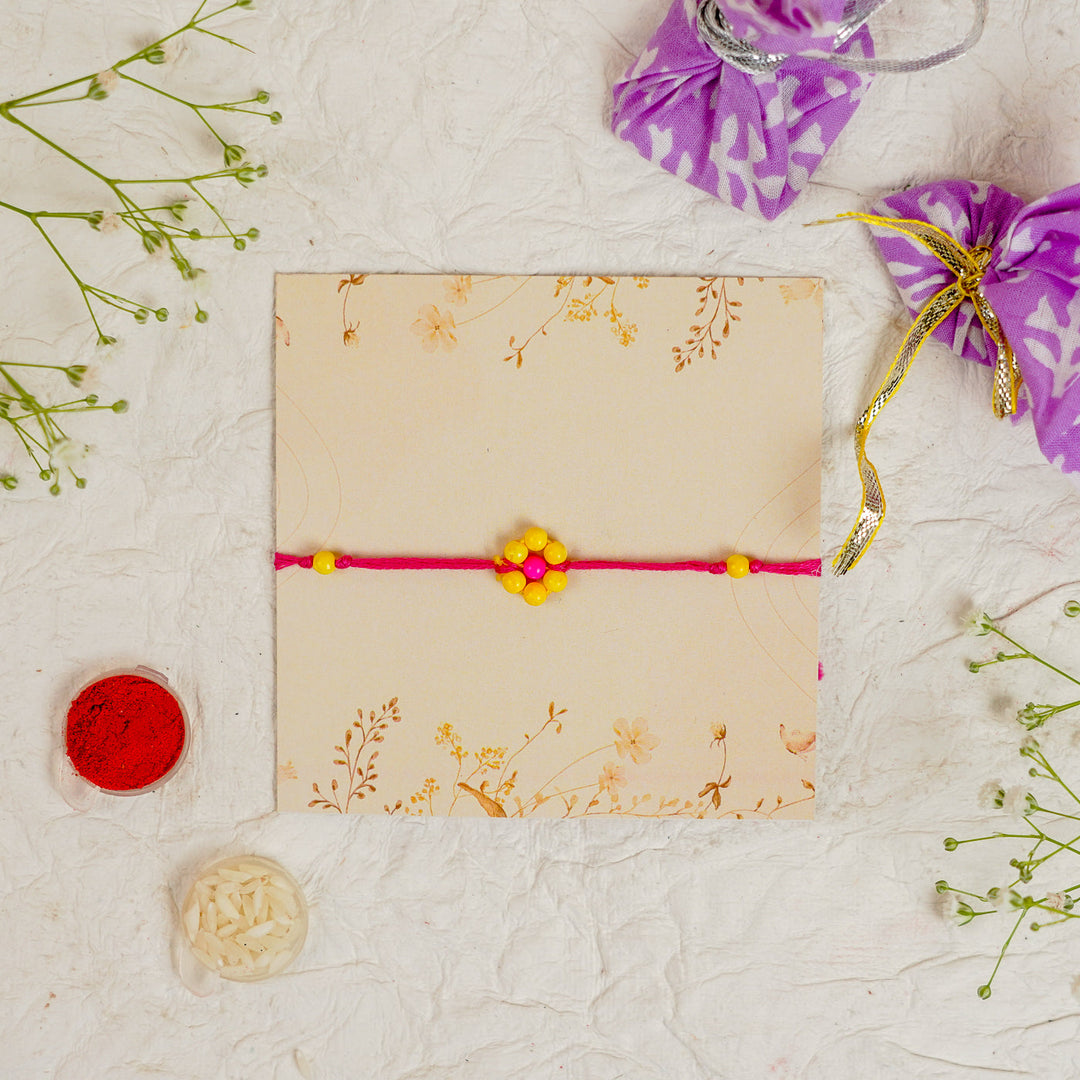 Handmade Beaded Flower Rakhi With Roli Chawal - Flat lay with box and accessories (8)