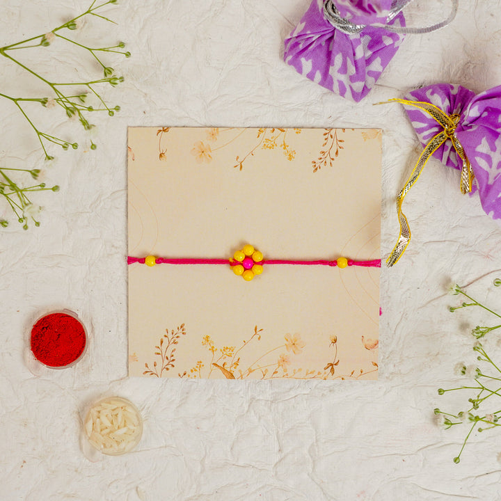 Handmade Beaded Flower Rakhi With Roli Chawal - Flat lay with box and accessories (8)