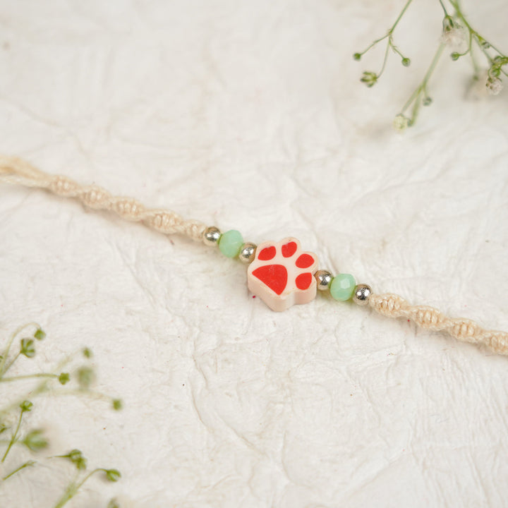Handmade Paw Kids Rakhi With Roli Chawal - Close-up Red Paw Charm