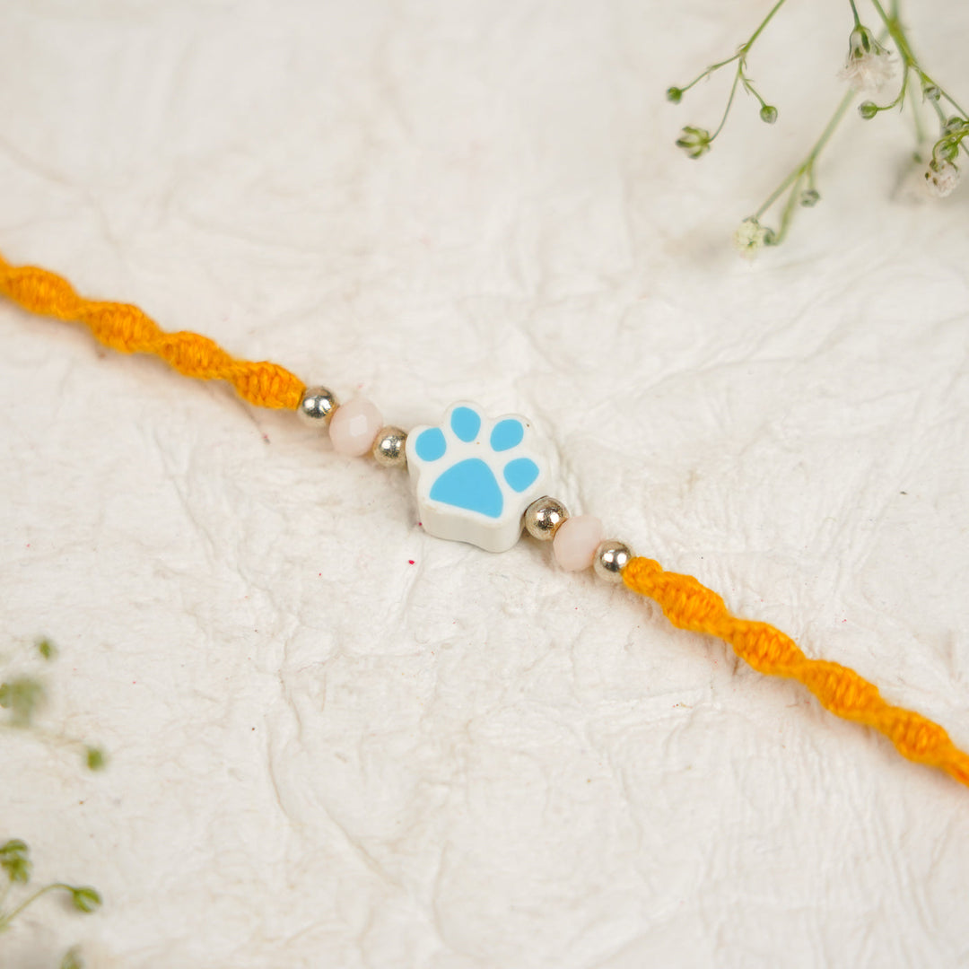 Handmade Paw Kids Rakhi With Roli Chawal - Close-up Blue Paw Charm