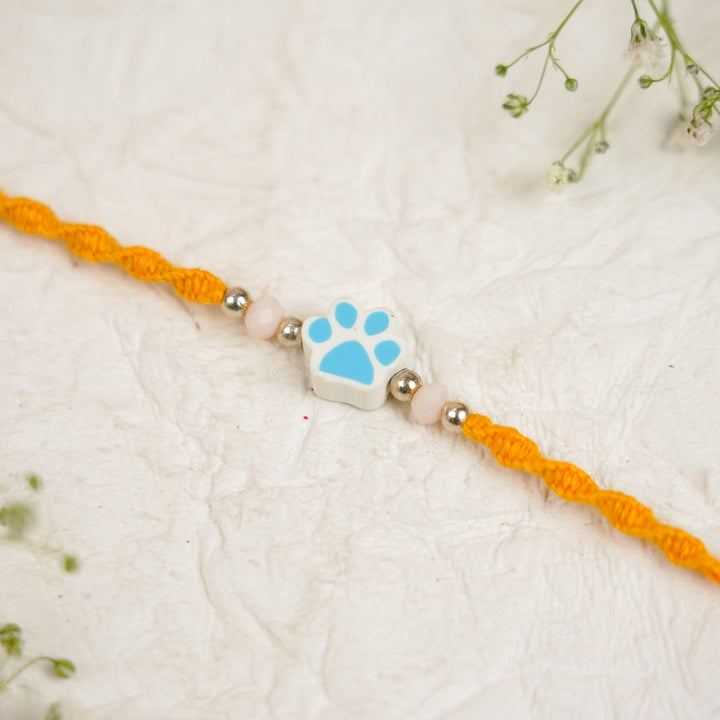 Handmade Paw Kids Rakhi With Roli Chawal - Close-up Blue Paw Charm