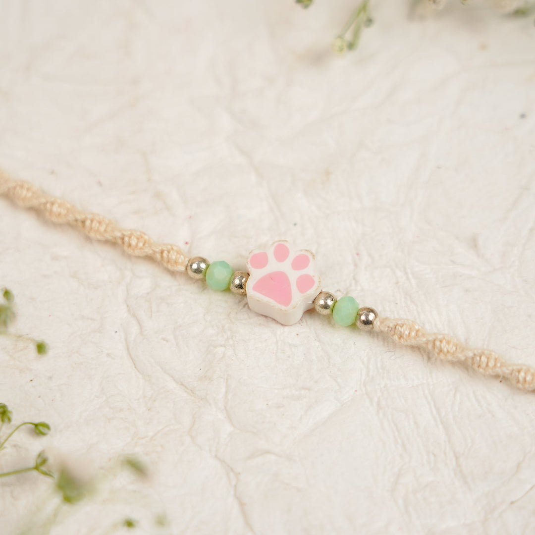 Handmade Paw Kids Rakhi With Roli Chawal - Close-up Light Pink Paw Charm